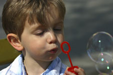 Boy blowing bubbles
